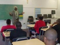 Man speaking to students in a classroom